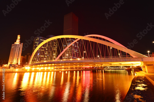 Fototapeta Naklejka Na Ścianę i Meble -  The modern city highway Bridges night landscape car light trails arc in tianjin