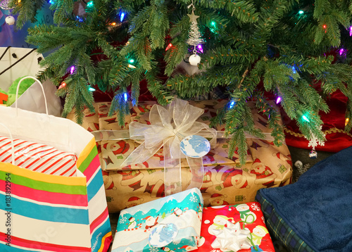 Close up on gift bags and boxes under Christmas tree