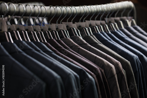 Row of men suit jackets on hangers