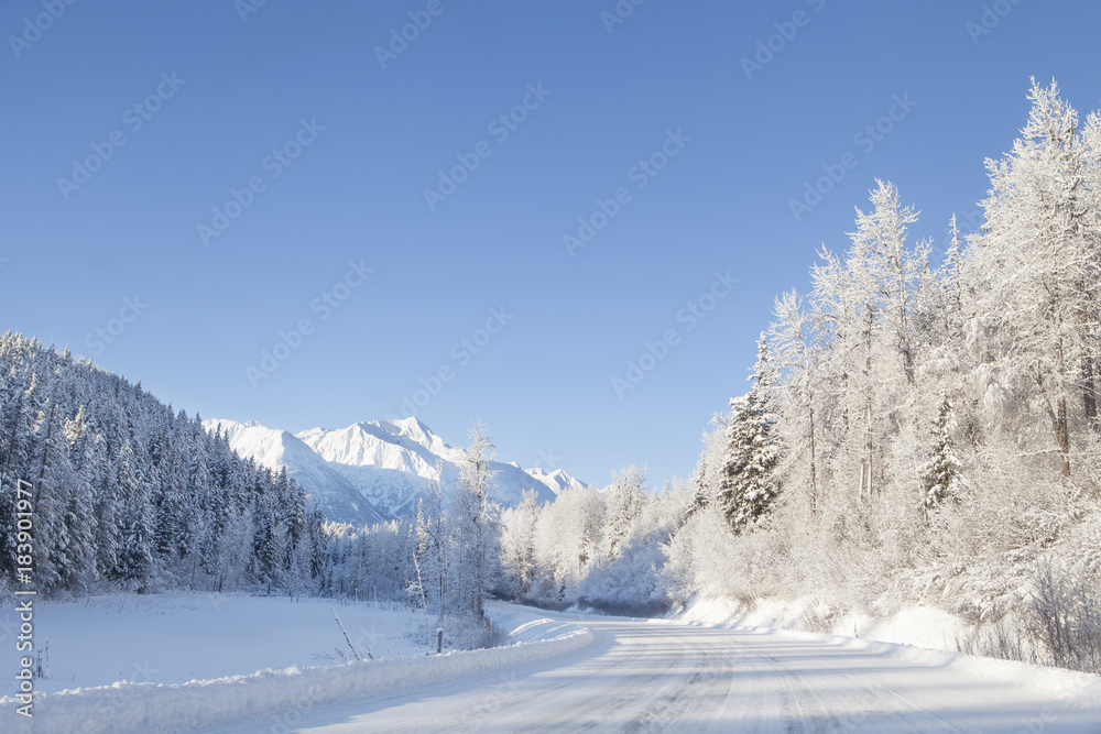 Snowy road with mountains