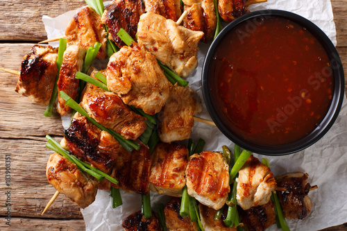 Chicken kebabs with green onions in a spicy sauce - Dakkochi close-up. Horizontal top view
 photo