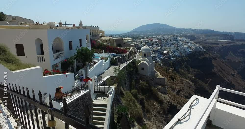 SANTORINI, GREECE – AUGUST 2016 : Video shot of Santorini cityscape on a sunny day with iconic buildings and people walking in view SANTORINI, GREECE – AUGUST 2016 : Video shot of Santorini cityscape on a sunny day with iconic buildings and people walking in view