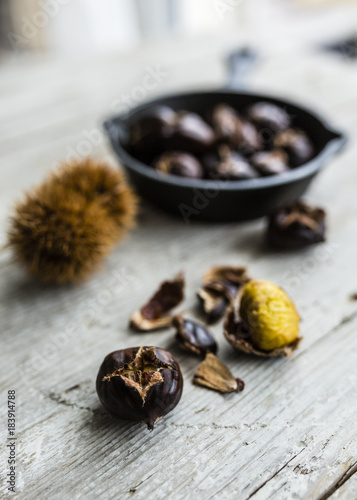 Roast chestnuts on a wooden rustic table. 