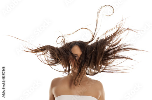 young happy woman with flying hair on white background