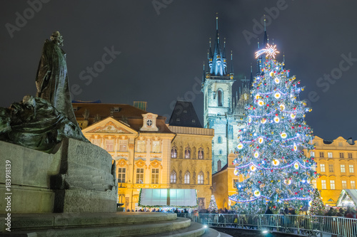 Christmas Markets and Tree on the Old Town Square in Prague with Statue of Mr. Jan Hus in the foreground.
