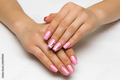 gently pink manicure with sparkles with painted hearts and arrows on square long nails