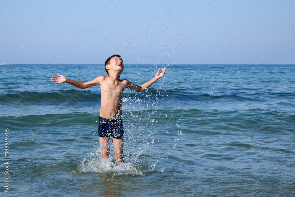 Happy boy playing in sea