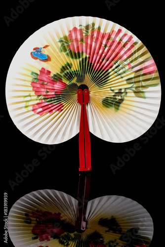 Closeup of Traditional Chinese fan on black background.