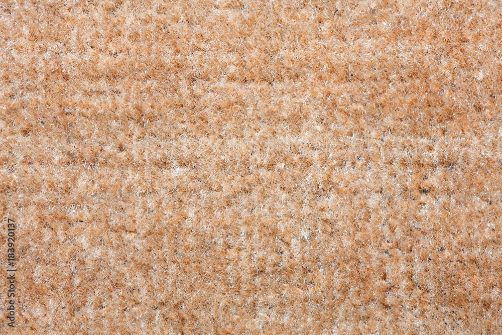 Fototapeta premium Beige carpet texture. A close up background