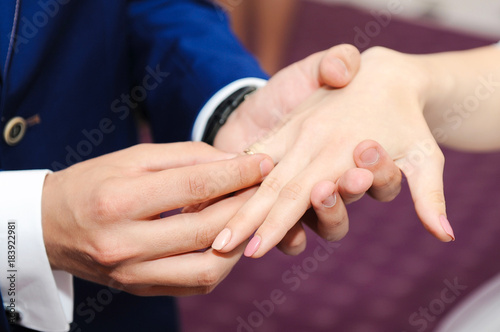 Marriage hands with rings. Groom wears the ring on the finger of the bride