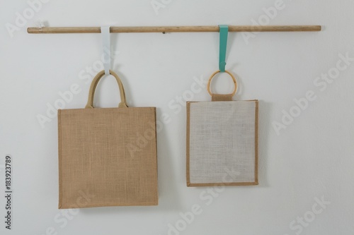 Two bags hanging on wooden rod