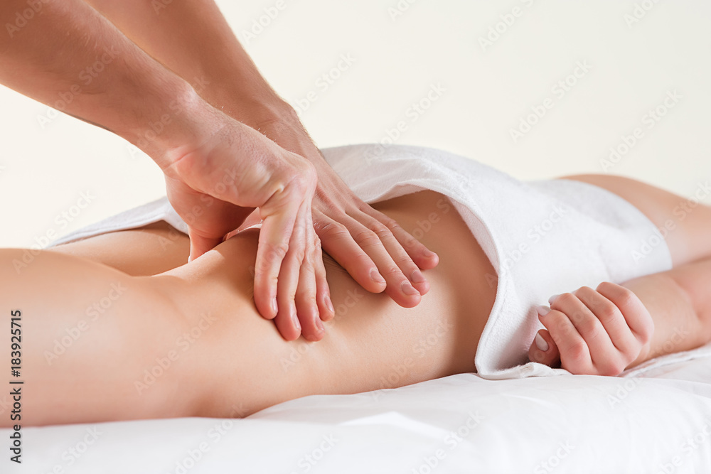 Detail of hands massaging human calf muscle. Detail of hands massaging human calf muscle.