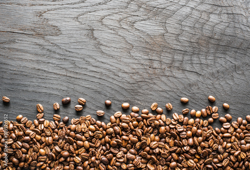 Roasted coffee beans on wooden table. Top view.