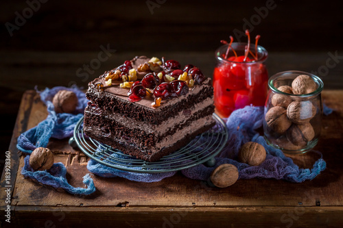 Delicious chocolate cake with walnuts and cherry
