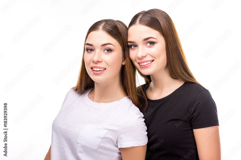 portrait of smiling twins in black and white stylish clothing isolated on white portrait of smiling twins in black and white stylish clothing isolated on white