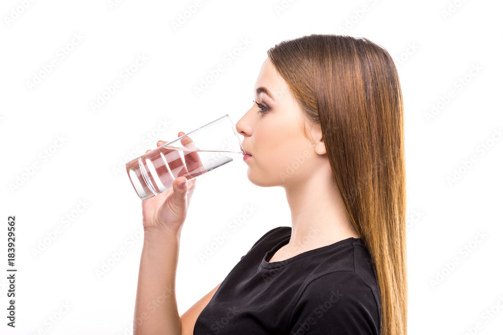 side view of young woman drinking water from glass isolated on white side view of young woman drinking water from glass isolated on white