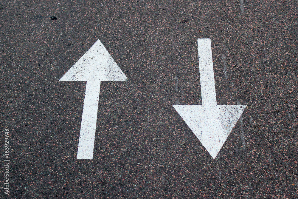 Two arrows on asphalt. Sign of two-way street.