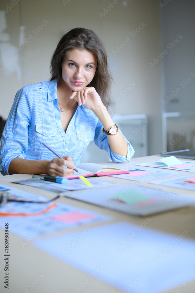 Young woman sitting at office table . Young woman. Young woman sitting at office table . Young woman.