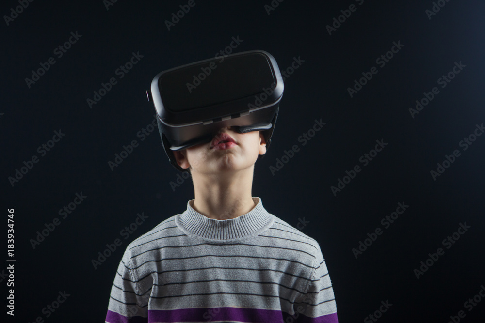 close-up boy 10 years old using a virtual reality helmet. Child getting experience in using VR 360 close-up boy 10 years old using a virtual reality helmet. Child getting experience in using VR 360
