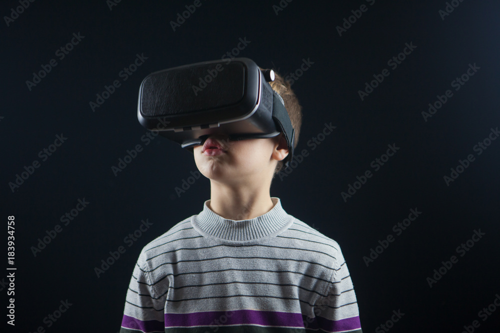 close-up boy 10 years old using a virtual reality helmet. Child getting experience in using VR 360 close-up boy 10 years old using a virtual reality helmet. Child getting experience in using VR 360