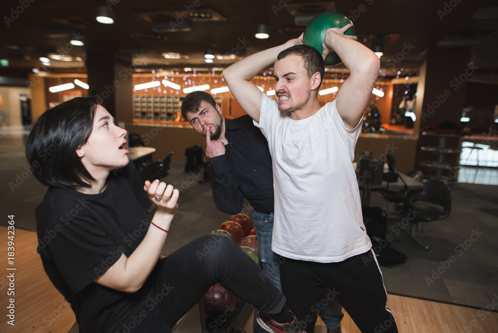 Funny fight of young people in bowling club. Stock Photo | Adobe Stock