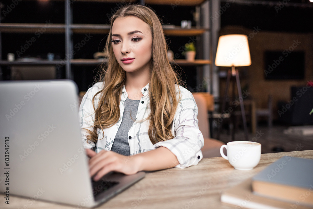 serious young businesswoman working with laptop at modern office serious young businesswoman working with laptop at modern office