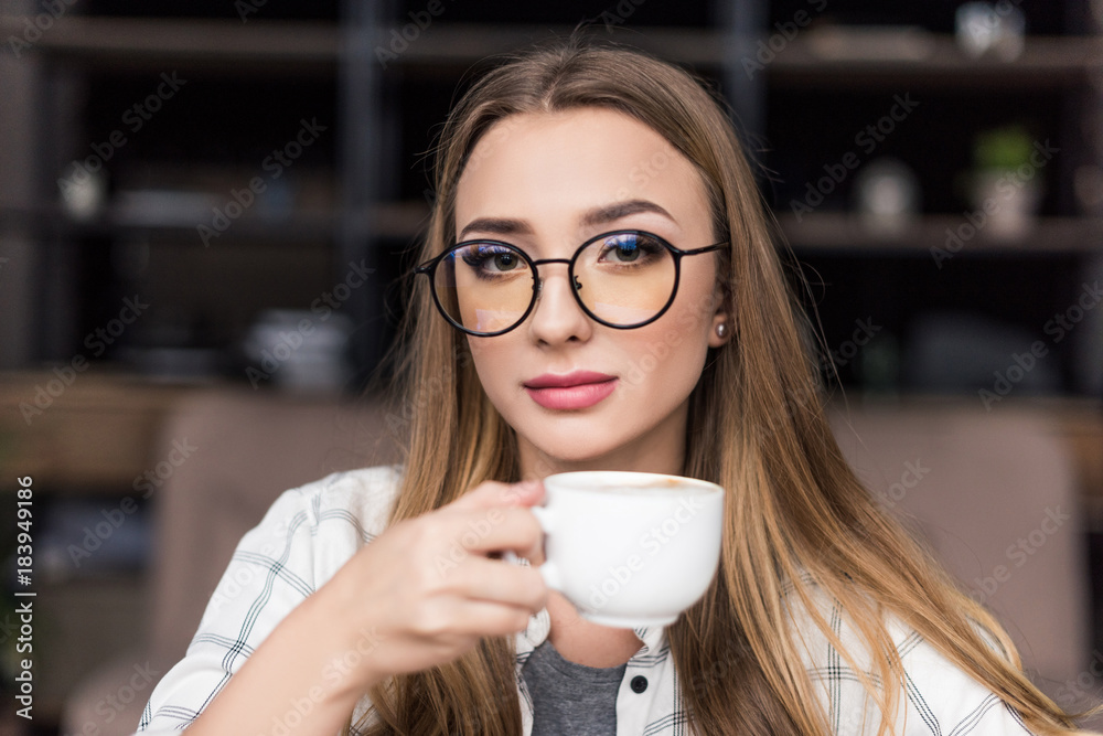 close-up portrait of beautiful young woman drinking coffee close-up portrait of beautiful young woman drinking coffee