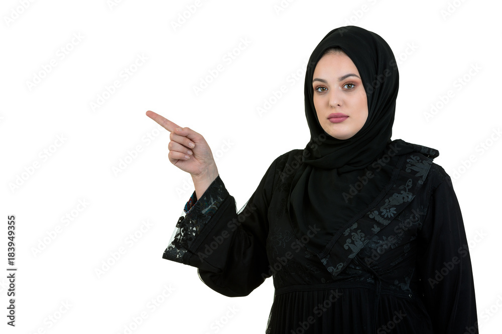 studio shot of young woman wearing traditional arabic clothing. she's holding her hand to the side studio shot of young woman wearing traditional arabic clothing. she's holding her hand to the side
