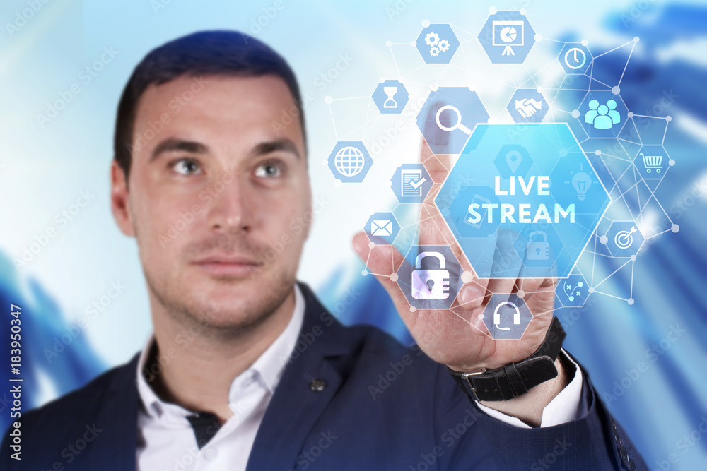 Business, Technology, Internet and network concept. Young businessman working on a virtual screen of the future and sees the inscription: Live stream Business, Technology, Internet and network concept. Young businessman working on a virtual screen of the future and sees the inscription: Live stream