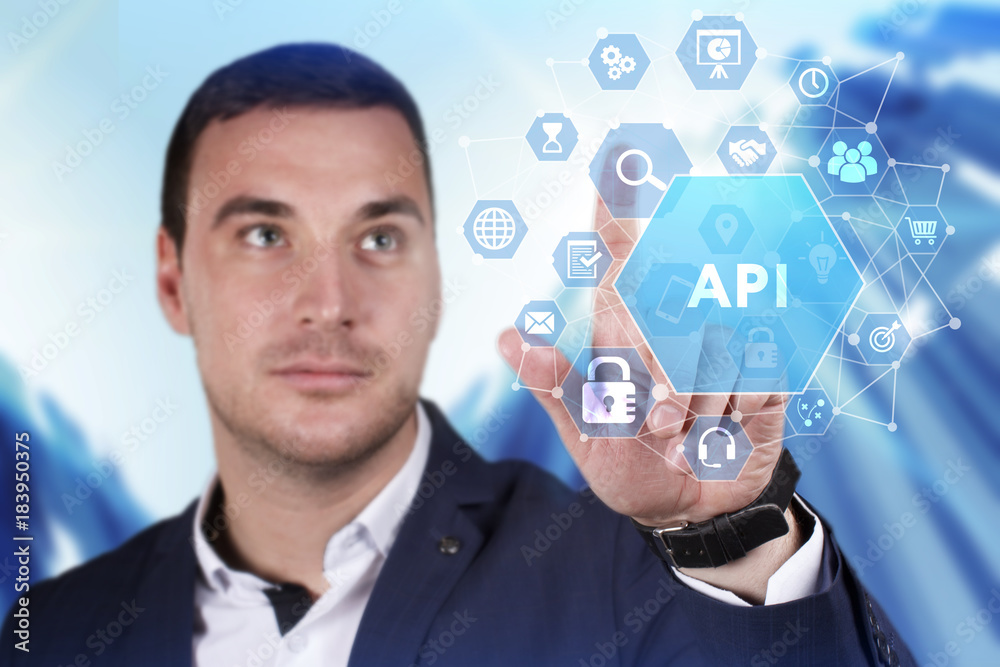 Business, Technology, Internet and network concept. Young businessman working on a virtual screen of the future and sees the inscription: API Business, Technology, Internet and network concept. Young businessman working on a virtual screen of the future and sees the inscription: API