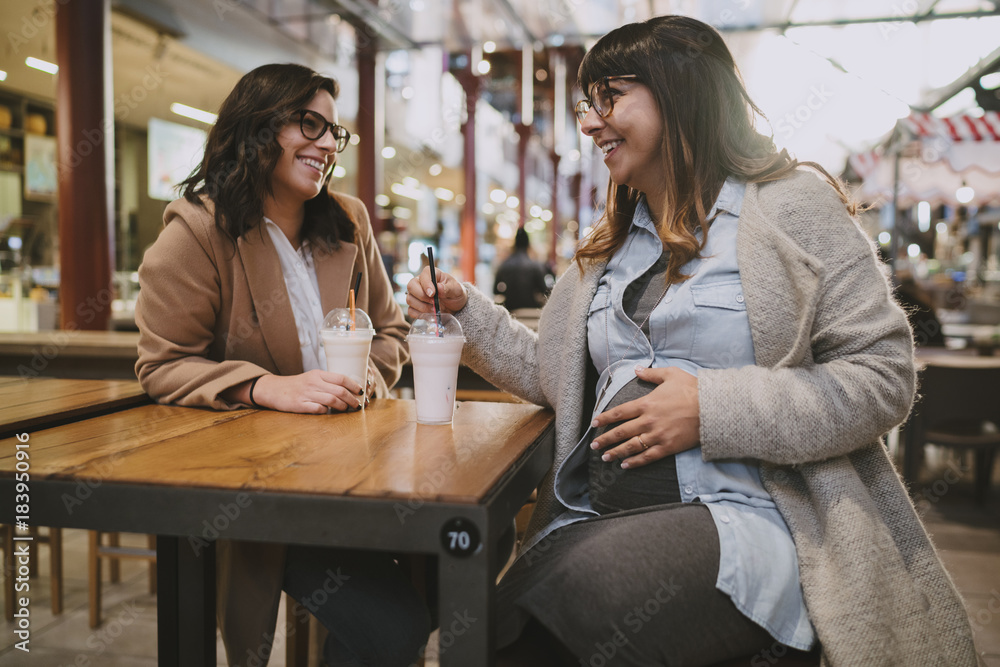 happy Pregnant woman meeting with a friend with gifts for her baby happy Pregnant woman meeting with a friend with gifts for her baby