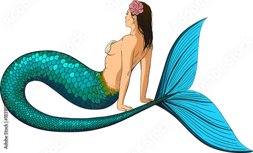 Young mermaid with a large fish tail and a hair woven into the hair sits and looks in the horizon
