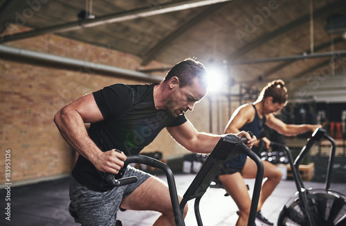 Man and woman training with gym equipment