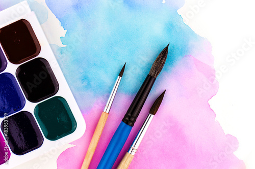 Palette of watercolor paints and brushes