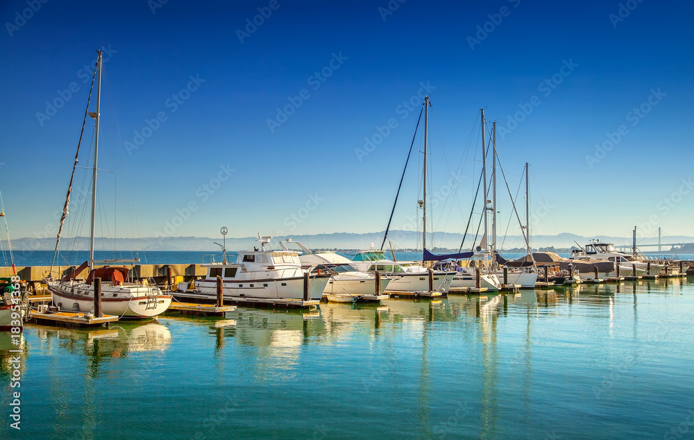 Boats and yachts at marina on sunny morning 