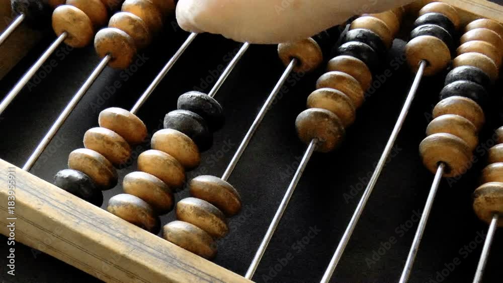 Video shows old wooden abacus. Man is making a calculation Video shows old wooden abacus. Man is making a calculation