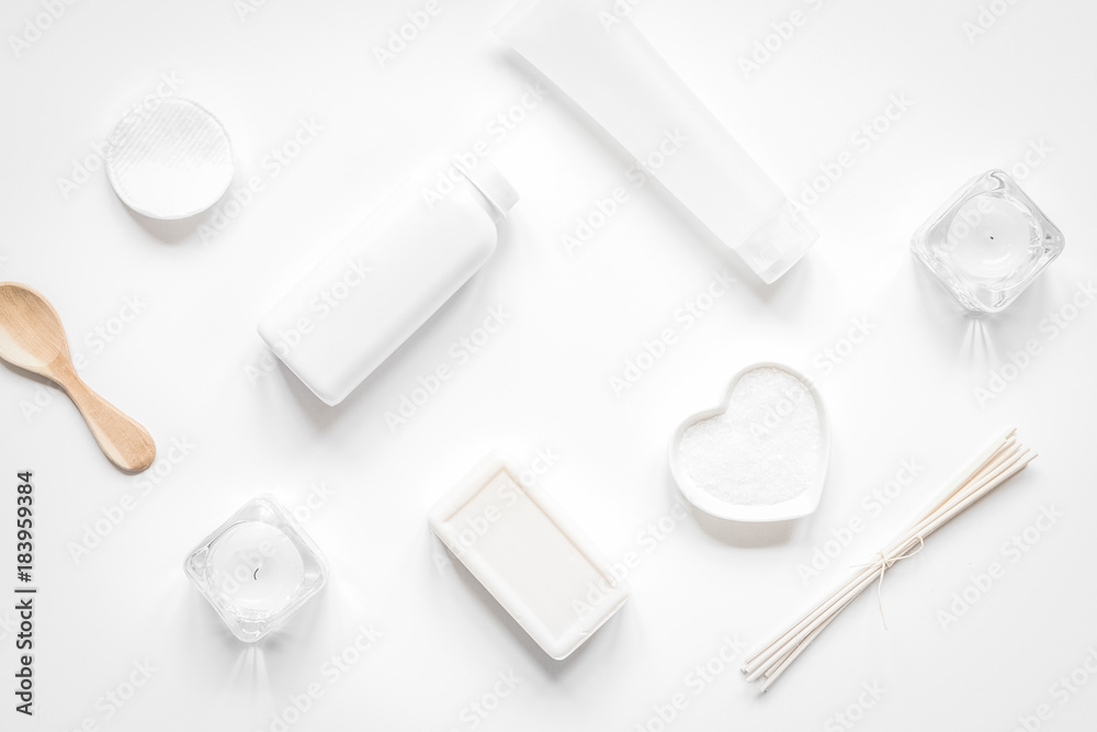 white set of cosmetics for spa on table background top view