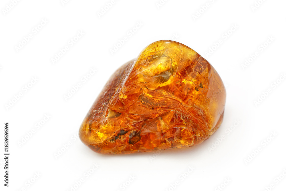 Amber. Very beautiful piece of amber with waves and patterns inside on a white background. It looks like hohlomu. A natural stone. Fashionable decoration. A sunny stone. Vintage Wood Resin Amber. Very beautiful piece of amber with waves and patterns inside on a white background. It looks like hohlomu. A natural stone. Fashionable decoration. A sunny stone. Vintage Wood Resin