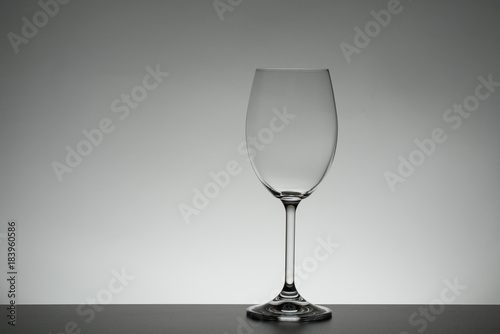 Crystal glass illuminated on mirror and black background