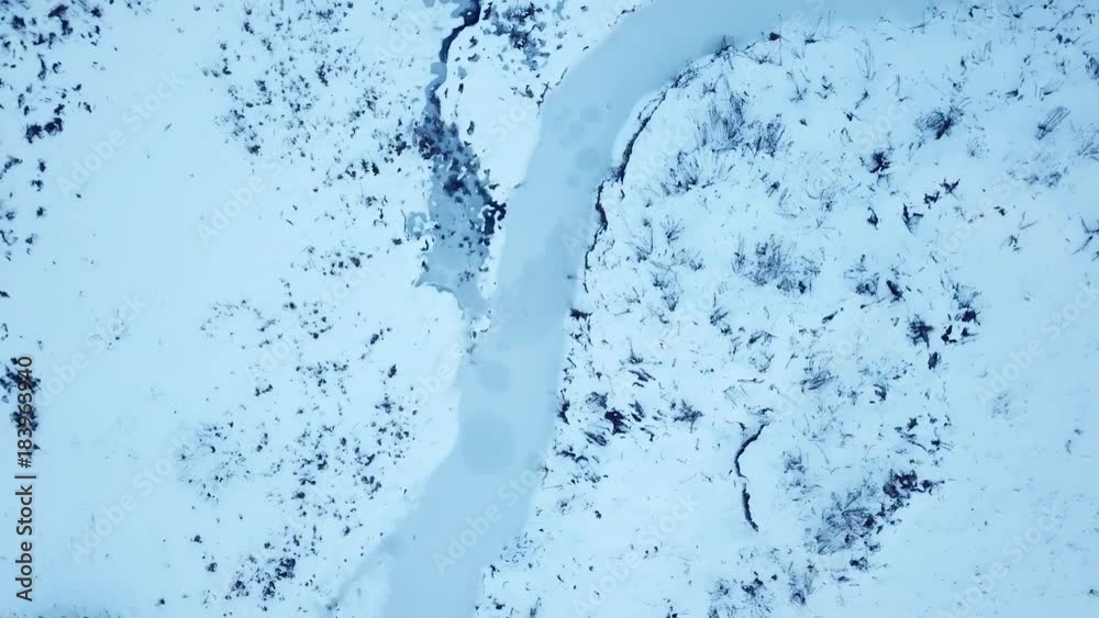 Small frozen river. Ice and snow. Aerial view landscape Small frozen river. Ice and snow. Aerial view landscape