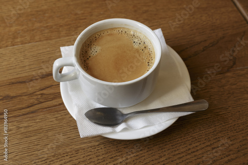 Cup of coffee for business breakfast. Wooden Background.