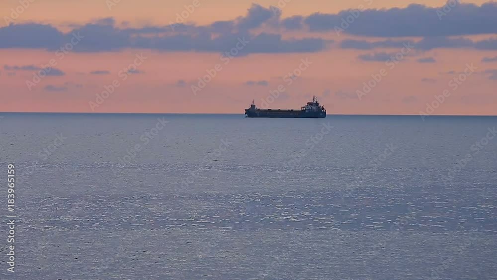 Big ships loaded with cargo sailing at sunset, goods export, Black Sea commerce Big ships loaded with cargo sailing at sunset, goods export, Black Sea commerce