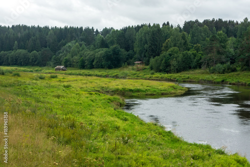 Fototapeta Naklejka Na Ścianę i Meble -  The river and the forest behind it.