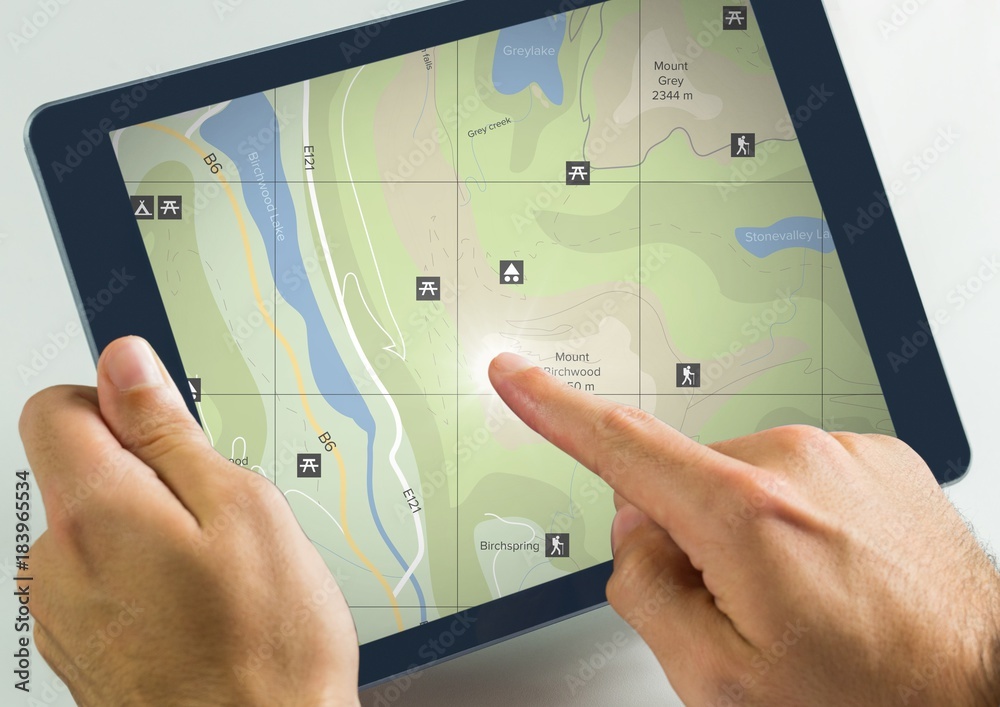 Hand touching tablet with map locations Hand touching tablet with map locations