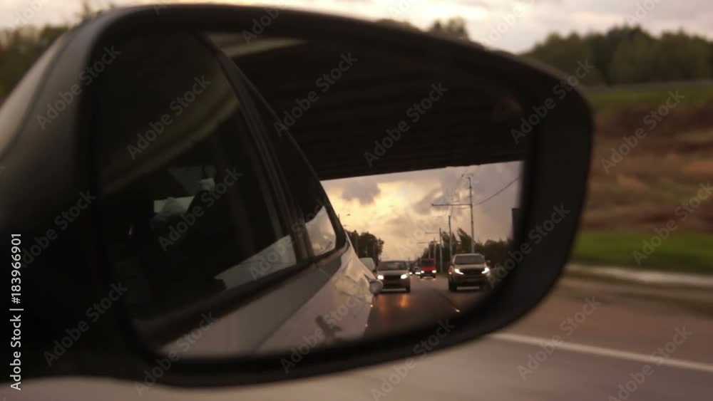 The view in the side rearview mirror. The view in the side rearview mirror.