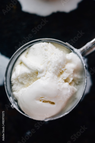 Ice cream starting to melt in metal ice cream scoop.