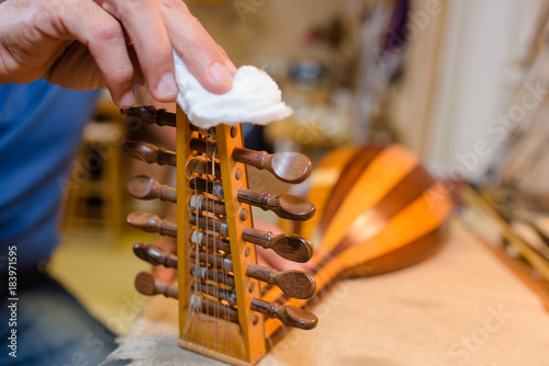 Fotografie Closeup of artisan working on a lute