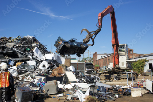 recycle cars and trucks being tossed to to scrap heap