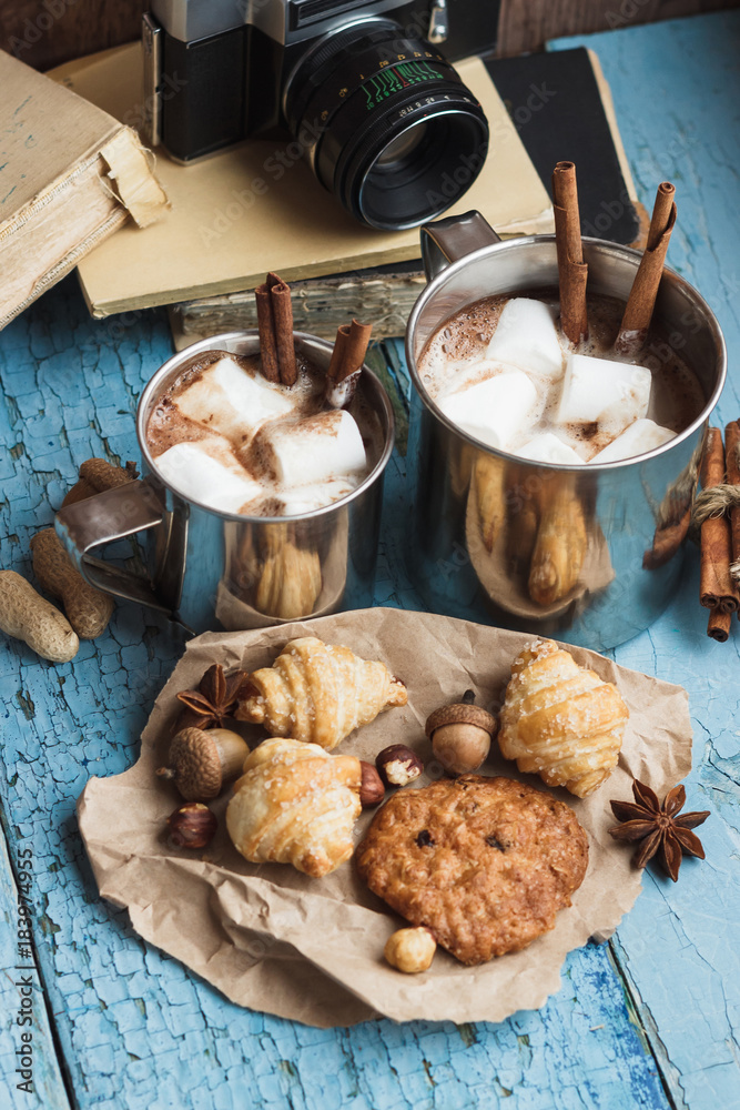 Metal cups with cacao and marshmallow and different cookies Metal cups with cacao and marshmallow and different cookies