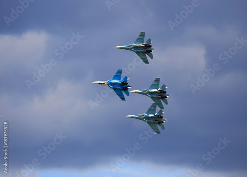 Fototapeta Naklejka Na Ścianę i Meble -  Fighters  flying in a cloudy sky